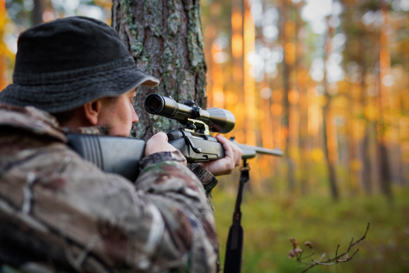 Hunter Looking into Rifle Scope